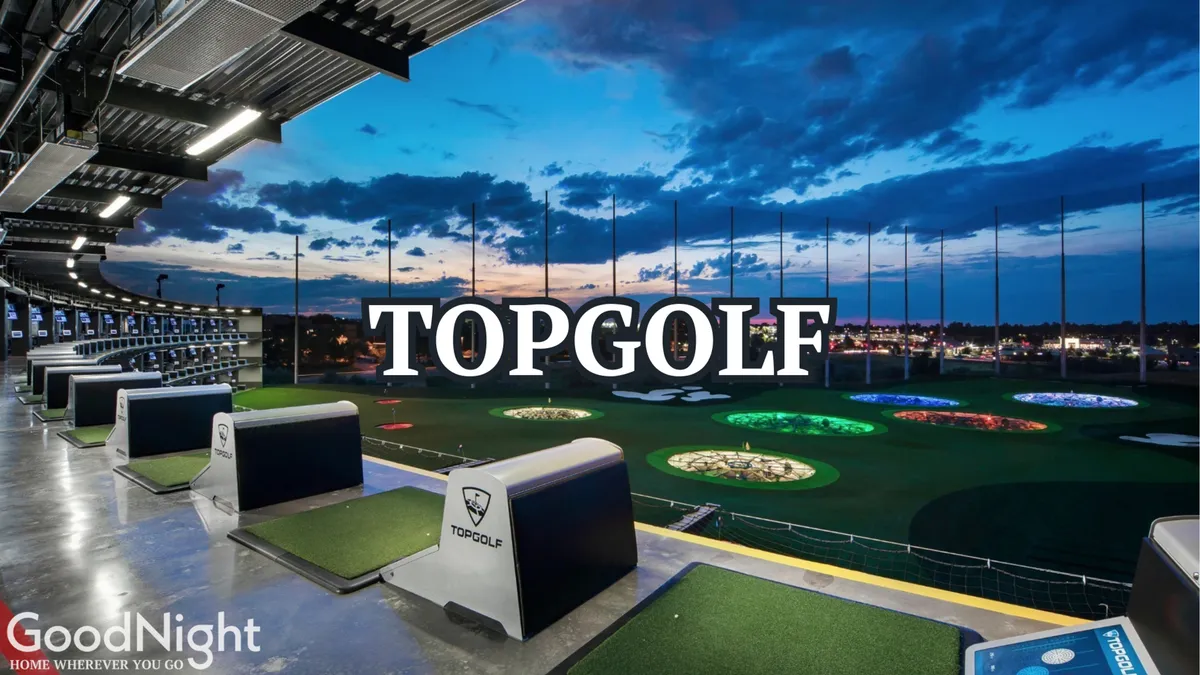 The image shows Topgolf’s open-air golf bays with colorful targets stretching out into the distance and the Nashville skyline visible beyond. Guests can be seen enjoying golfing, socializing, and dining, with a lively and playful atmosphere fitting for group outings and recreation.